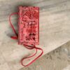 Red and red leather sling bag