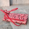 Red and red leather sling bag